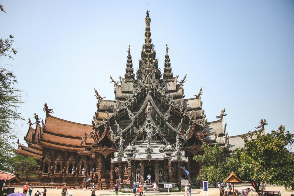 Majestic wooden temple showcasing intricate carvings and cultural architecture in Thailand.
