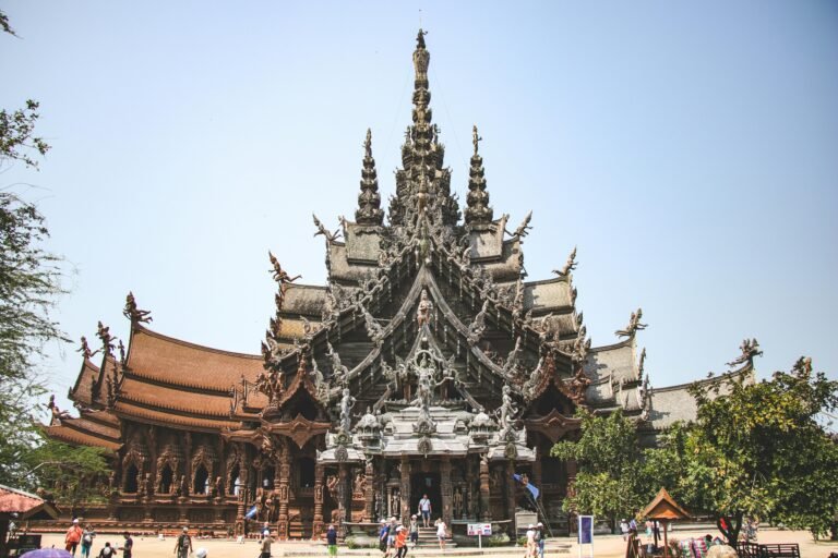 Majestic wooden temple showcasing intricate carvings and cultural architecture in Thailand.